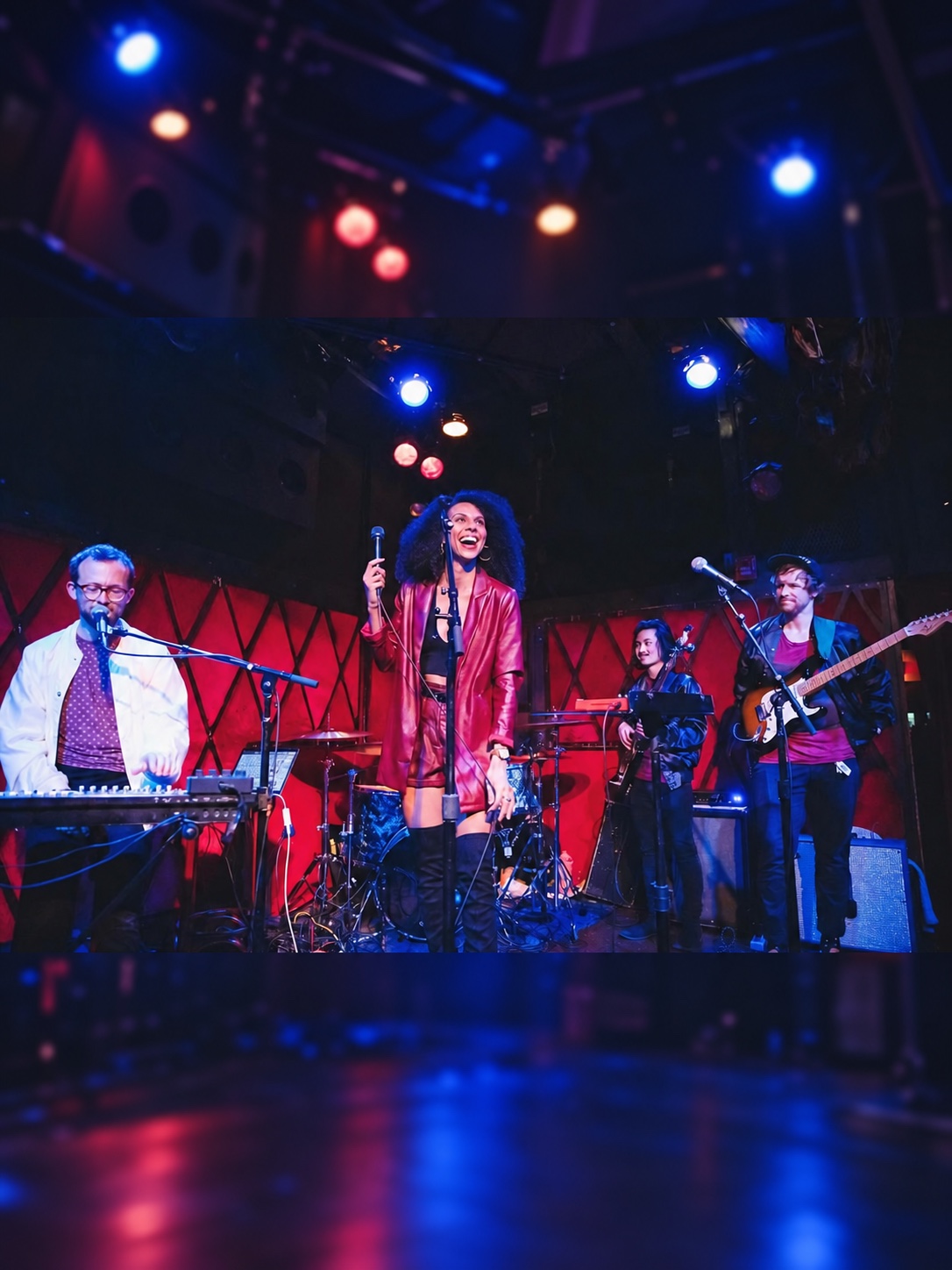 Lohai performs onstage under red and blue concert lights.
