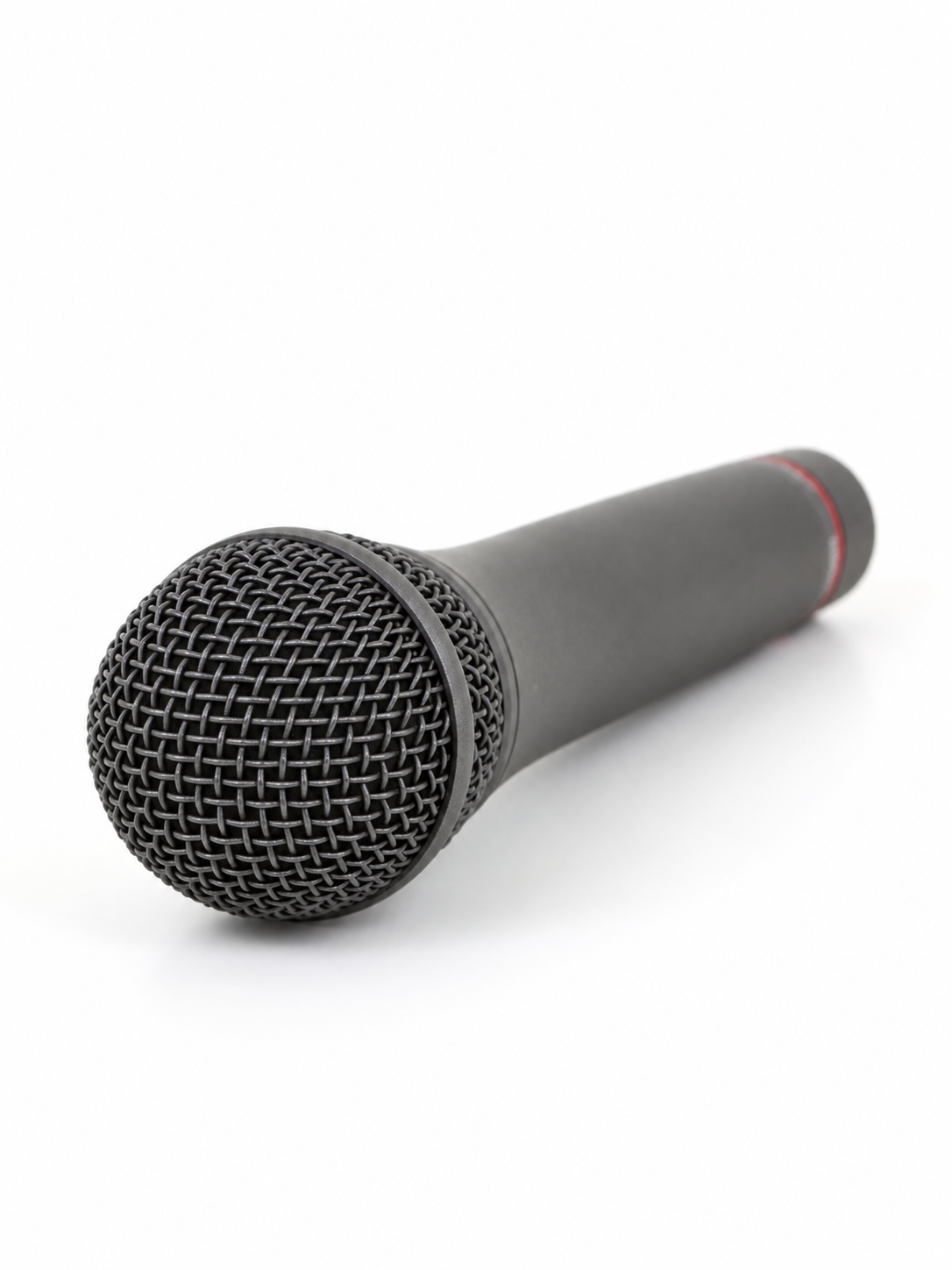 A handheld microphone lies diagonally on a clean white background.