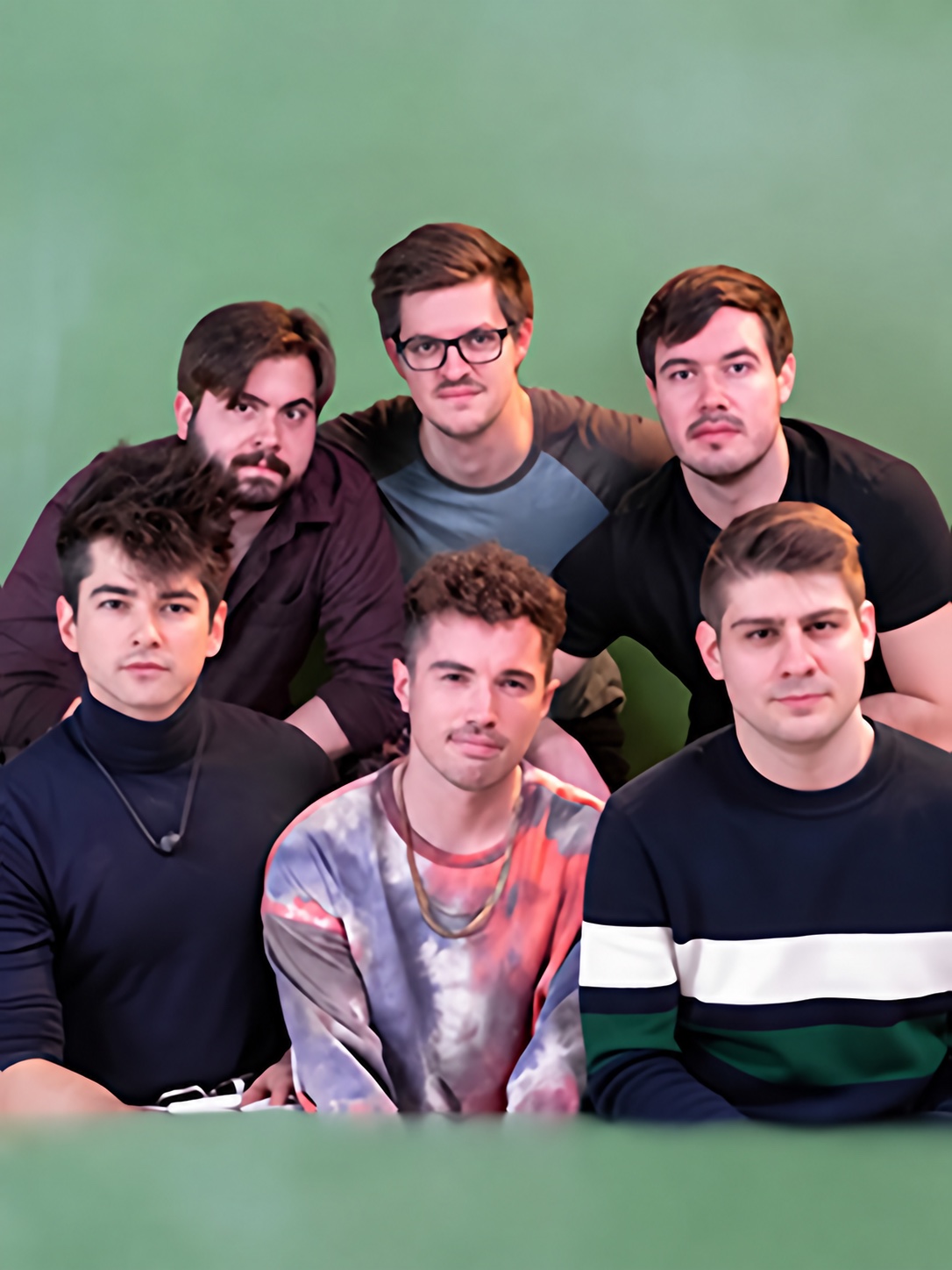 The six members of Sub-Radio pose together against a green background.