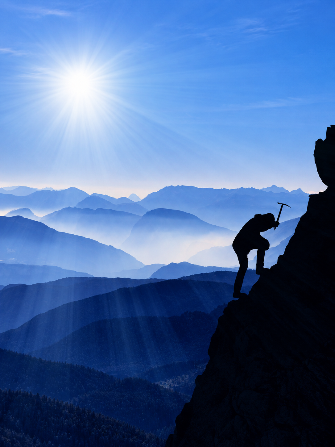 Silhouette of a climber ascending a mountain with an ice axe