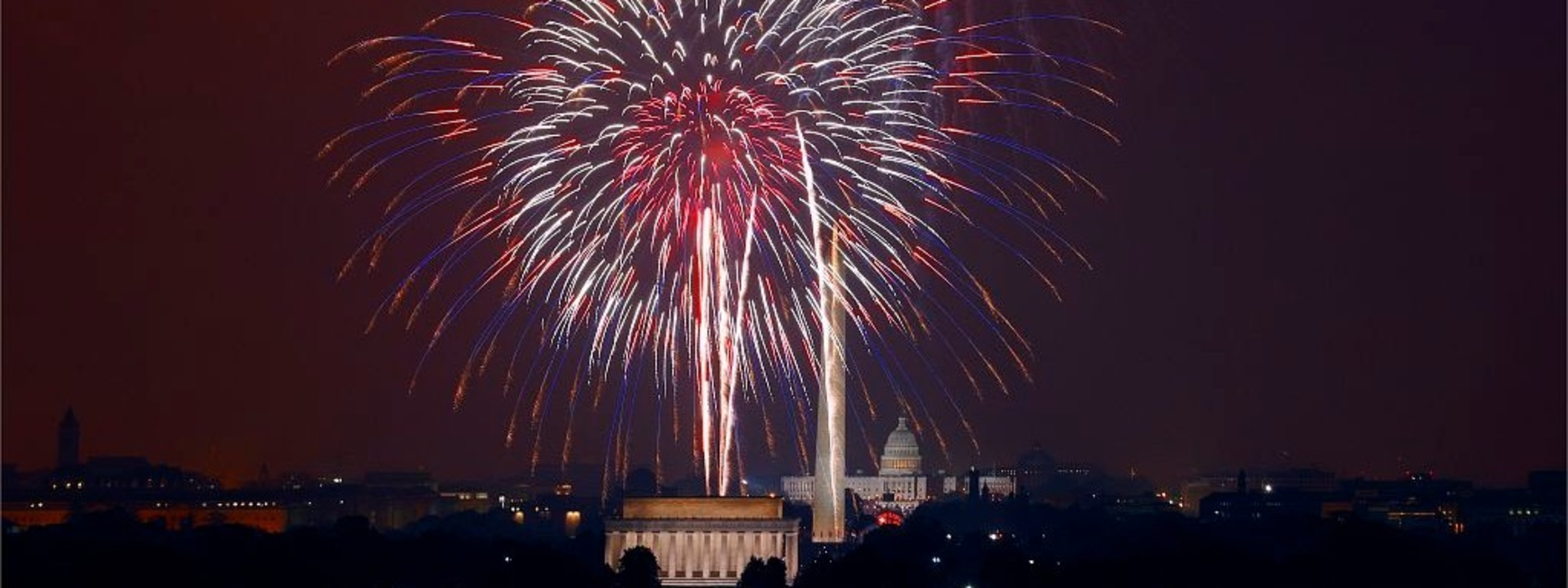 Fireworks light the sky above the Washington Monument and the U.S. Capitol.